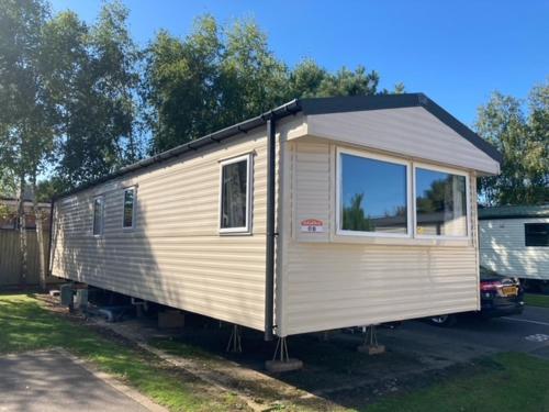 a tiny house is parked in a yard at Orchard Bank 8 in Hamworthy