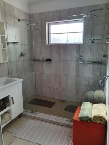 a bathroom with a shower with a glass door at 29 Jeffs Place in Yzerfontein