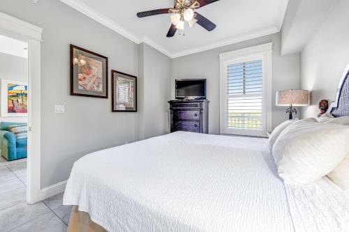 a bedroom with a white bed and a ceiling fan at The Grand #2703 in Destin
