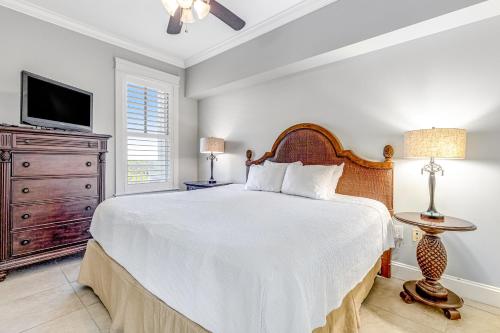 a bedroom with a large bed and a tv at The Grand #2703 in Destin