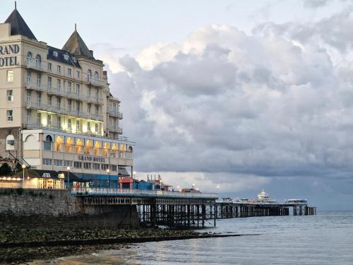 a building on a pier next to the water at Breeze B&B in Llandudno