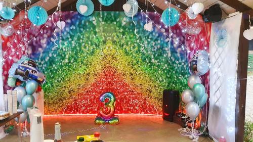 a rainbow room with a large wall of balloons at Przystań wodnica in Ustka