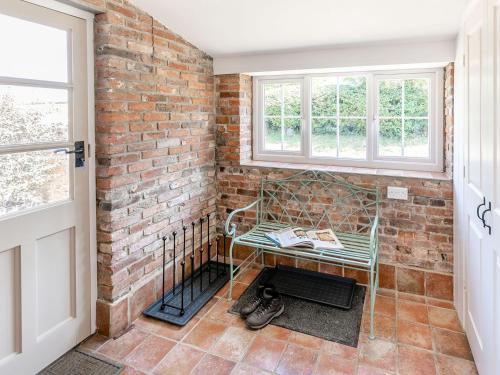 a room with a bench in a brick wall at The Hemmels in Brinkhill