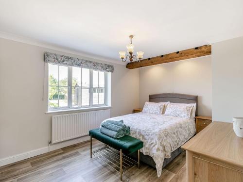 a bedroom with a bed and a window at The Hemmels in Brinkhill