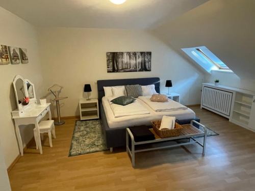 a bedroom with a large bed and a staircase at Ferienwohnung Zeitlos in Bad Bentheim