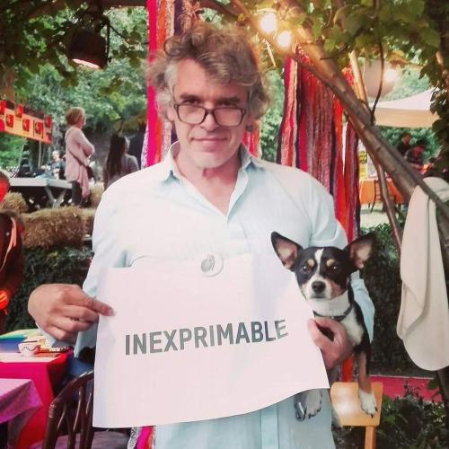 a woman holding up a sign with a small dog at Adventure Alternative - GUEST HOUSE - Arts-Factory-Experience - For artists, makers and open minds - Attention, we are not a hotel and are not adapted for everybody - Read host warnings before reservation - PROVIDENCE,BE asbl in Charleroi