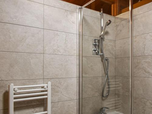 a shower in a bathroom with a glass door at Pine Lodge in Ellington