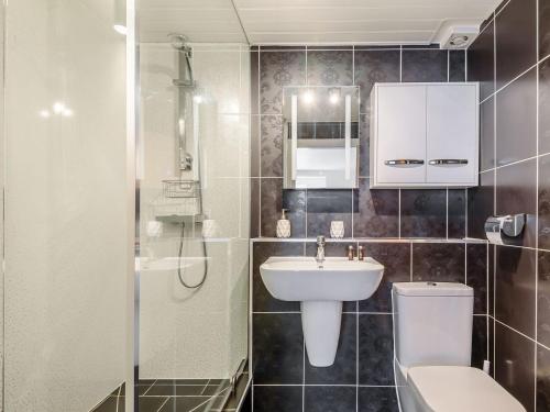 a bathroom with a sink and a toilet and a shower at The Paddocks in Ault Hucknall