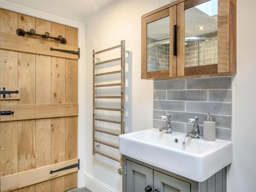 a bathroom with a sink and a mirror at The Old Stables - Uk38576 in Aston Cantlow