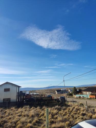 a cloud in the sky over a field at Azules 2721 in El Calafate
