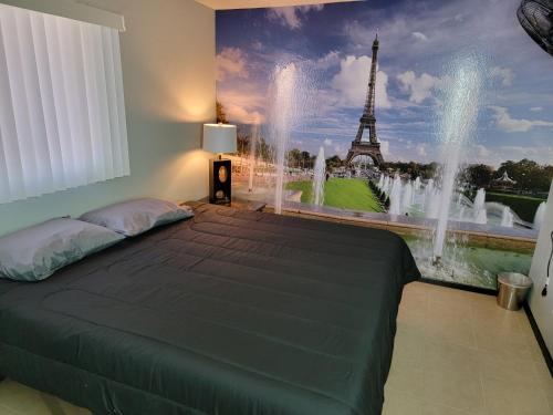 a bedroom with a bed with a mural of the eiffel tower at Orangewood & 51Ave Homestay - Not a Hotel in Glendale