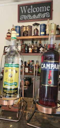 two bottles of alcohol sitting on top of a counter at Blue Paloma Bed & Breakfast in Lucea