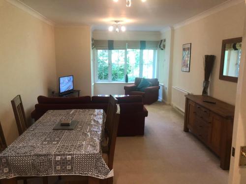 a living room with a couch and a table at Lovely 2 bedroom 2 baths flat with free parking in Basingstoke