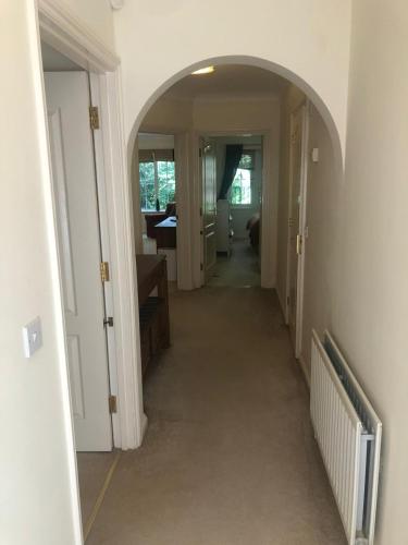 un pasillo con un arco en una casa en Lovely 2 bedroom 2 baths flat with free parking en Basingstoke