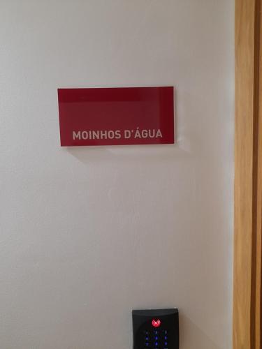 a sign on a wall above a clock on a wall at Casas da Serra - Soeima Housing in Alfândega da Fé