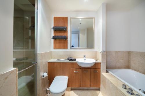 La salle de bains est pourvue d'un lavabo, de toilettes et d'une baignoire. dans l'établissement Luxury Penthouse Apartment, à Auckland