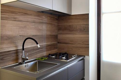 a kitchen with a sink and a stove at Dadà Suites in Catania