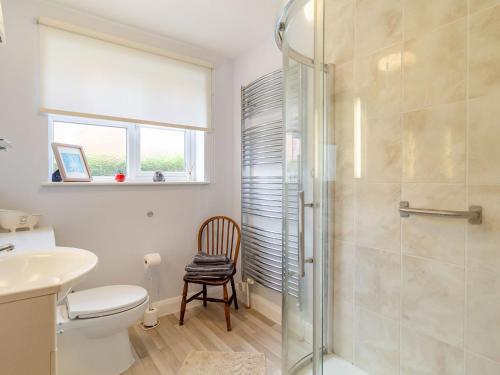 a bathroom with a shower and a toilet and a sink at Stellas Retreat in Loddon