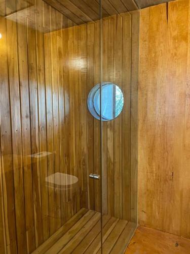 a sauna with a glass door and a window at Chalet nordico enmedio del bosque in Mineral del Monte