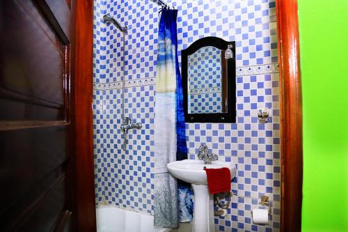 a bathroom with a sink and a mirror at Plot 4 Kavuma Close in Kampala