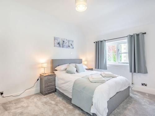 a bedroom with a bed and a window at Capel Y Ffynnon in Llandudno Junction