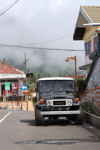 an old truck parked on the side of a street at Good Karma Bromo Guesthouse in Bromo
