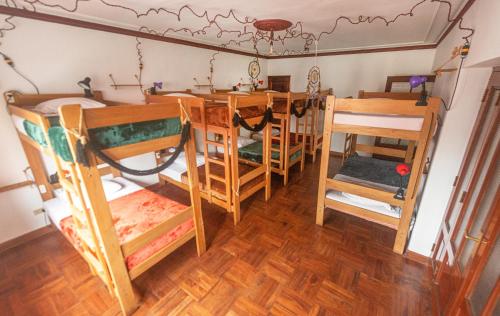 a room with a table and chairs in a room at KACLLA, The Healing Dog Hostel in Lima