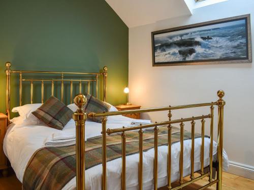 a bedroom with a bed and a picture on the wall at The Hayloft in Crosby Garrett