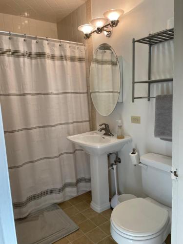 a bathroom with a sink and a toilet and a mirror at Turnagain Guest House in Anchorage