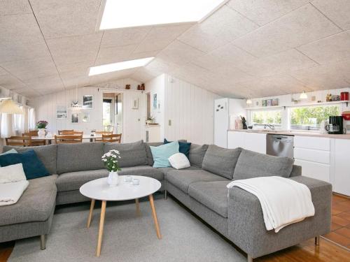 ein Wohnzimmer mit einem Sofa und einem Tisch in der Unterkunft Holiday home Blokhus XLII in Blokhus