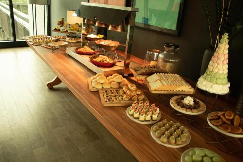 a long table filled with different types of pastries at Midori Clark Hotel and Casino in Clark