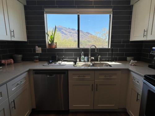 a kitchen with a sink and a window at The Desert Oasis at #LambertPark Tucson - 4BD + Unobstructed Mountain Views in Tucson