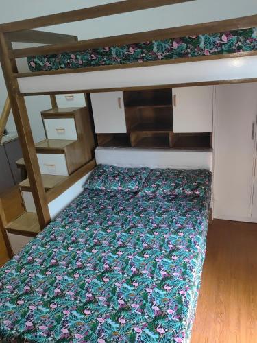 a bunk bed with a floral bedspread on it at Salcedo's Units in Baguio