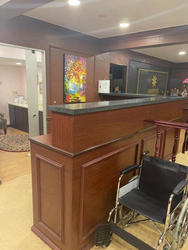 a bar in a lobby with a chair in front of it at Grand Illusyin in Shah Alam
