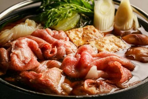 a bowl of food with meat and vegetables on a table at NIPPONIA HARIMA FUKUSAKI ZOUSHONO YAKATA in Fukusaki