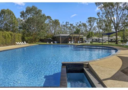 a large swimming pool in front of a building at Discovery Parks - Nagambie Lakes in Nagambie