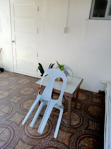 a white chair sitting on top of a table at Okoy Guest House in Bantayan Island