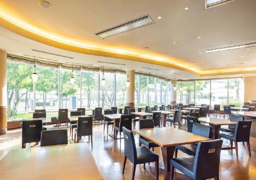 a dining room with tables and chairs and windows at Tokyo Bay Ariake Washington Hotel in Tokyo