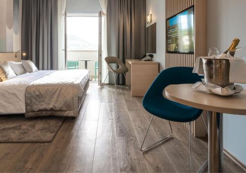 a hotel room with a bed and a table and a chair at Berkeley Hotel & Day Spa in Dubrovnik