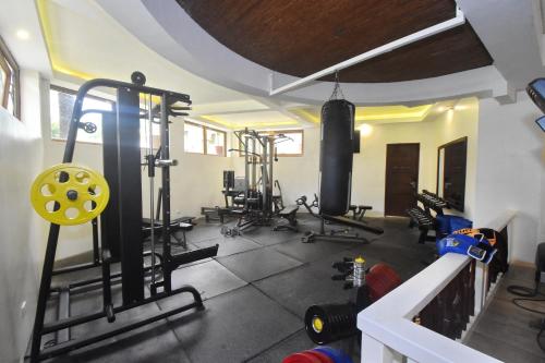 a gym with several treadmills and machines in a room at Ambassador In Paradise in Boracay