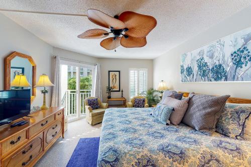 a bedroom with a bed and a ceiling fan at Peaceful Ocean Retreat in East End