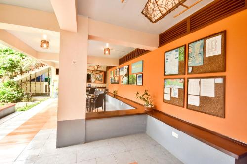 a lobby of a building with orange walls at Agos Boracay Rooms + Beds in Boracay