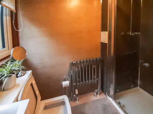 a bathroom with a shower with a toilet and a sink at Hilbre in Strachur