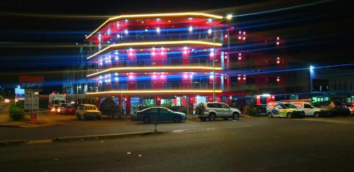 a building with cars parked in a parking lot at night at Nadi Airport Transit Hotel in Nadi