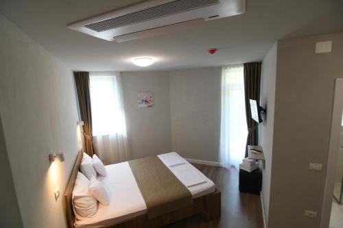 une chambre d'hôtel avec un lit et une fenêtre dans l'établissement Octogon, à Băile Felix