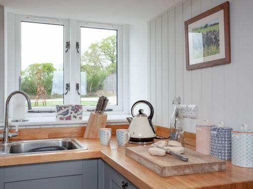 a kitchen counter with a sink and a kettle at Upper Red Down - Uk37699 in Witheridge