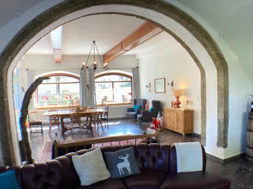 an archway in a living room with a couch and a table at Haus Standlgut Rauris -- incl Sommercard in Rauris
