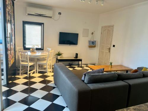 a living room with a couch and a table at Shantell Luxury Apartment in Netanya