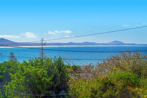 a view of the ocean with mountains in the distance at Bally High, 20 Dulconghi Street in Crescent Head