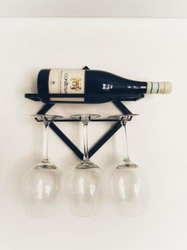 a bottle of wine sitting on top of two wine glasses at Bella Pescara Bb - Abruzzo, Italy in Pescara